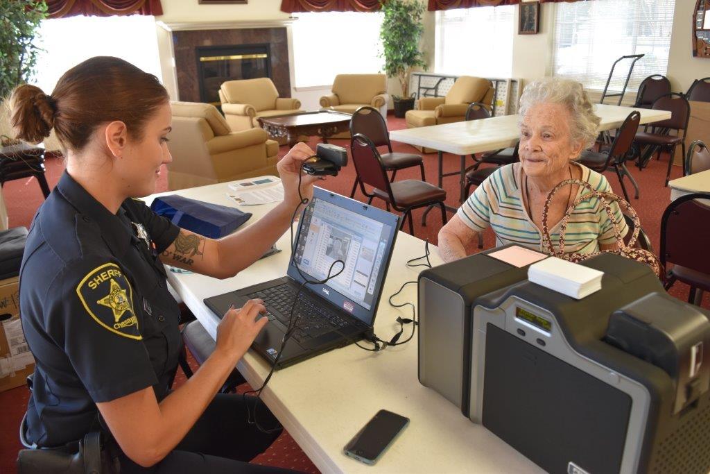 Picture of Deputy Taking picture for Senior ID